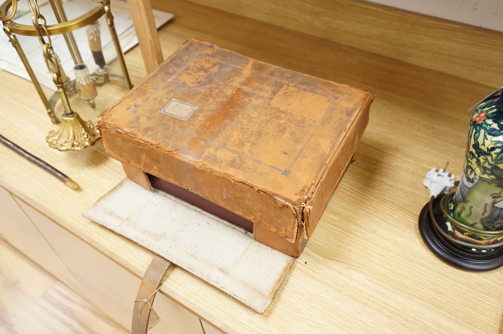 A cased travelling lock box with Bramah lock and leather case, no key, 36cm high
